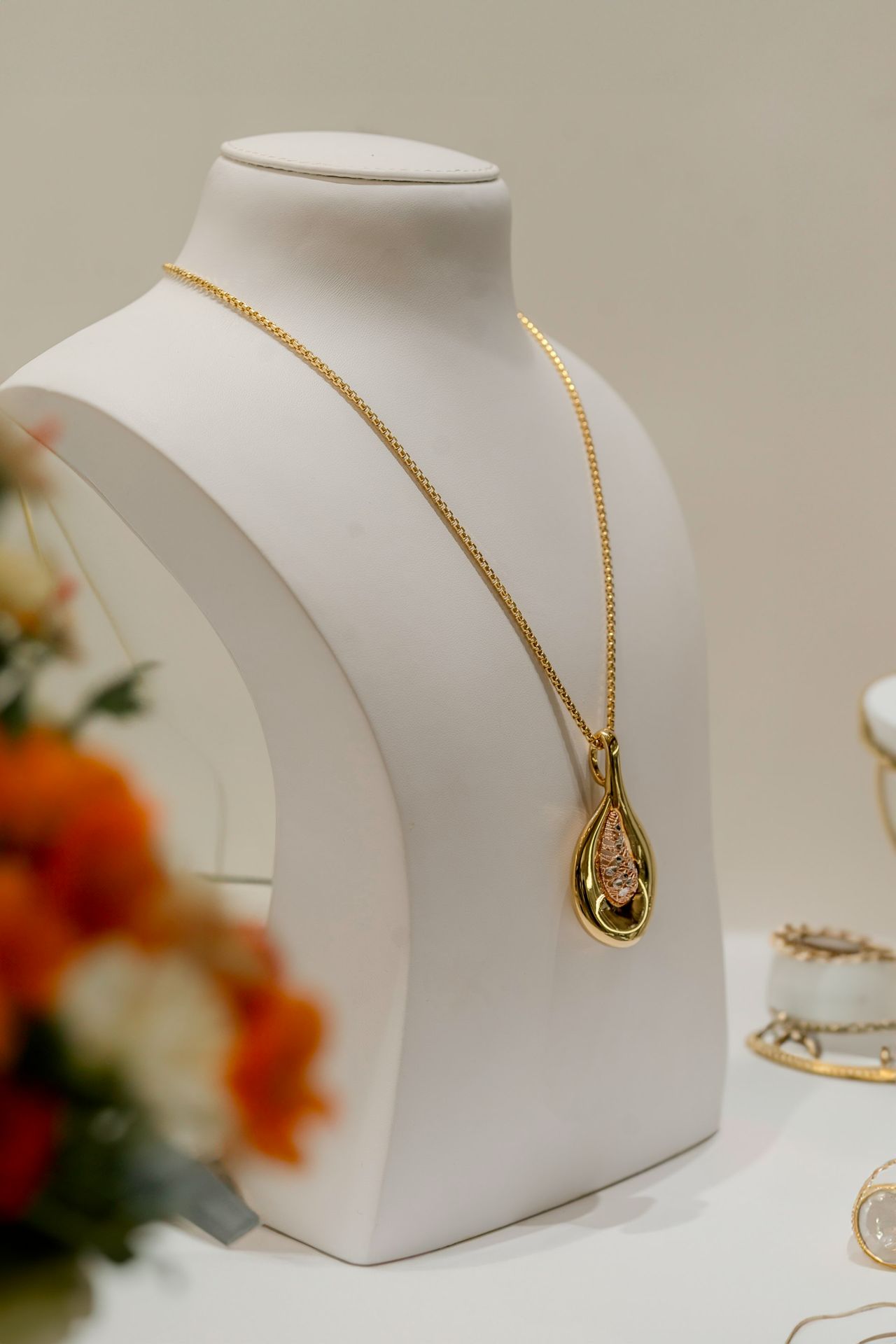 a white mannequin with a necklace on it